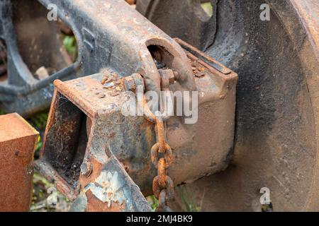 Fotografia della vecchia catena arrugginita su un complessivo ruota portante del treno che è stato scollegato dal carrello Foto Stock