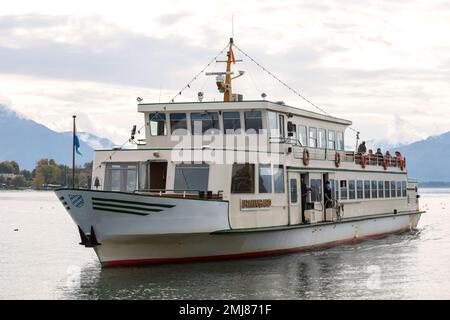 Gstadt am Chiemsee, Germania - 11 ottobre 2022: Traghetto turistico che arriva al molo di Gstadt am Chiemsee. Porta turisti al Frauen insel A. Foto Stock