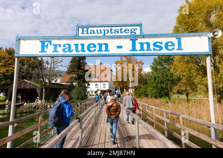 Gstadt am Chiemsee, Germania - 11 ottobre 2022: I turisti arrivano al Frauen insel in autunno per visitare l'Abbazia di Frauenwörth a Chiemsee. Foto Stock