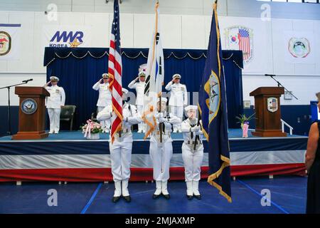 JINHAE, Repubblica di Corea - la guardia di colore presenta i colori mentre il partito ufficiale rende onore durante la cerimonia del Cambio di comando al Comandante, Fleet Activities Chinhae (CFAC), 26 agosto 2022. Durante la cerimonia, CMdR. Preston Rackauskas ha sollevato il CMdR. Michael Vaas, diventando il 20th° comandante della CFAC. Foto Stock