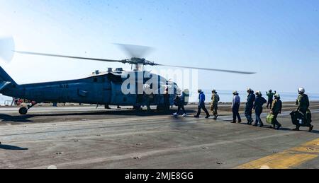 220827-N-FB730-1034 IONIAN SEA (27 agosto 2022) marinai della portaerei di classe Nimitz USS Harry S. Truman (CVN 75), a bordo di un elicottero MH-60s Sea Hawk, collegato al 'Night Dippers' di Helicopter Sea Combat Squadron (HSC) 5, per il transito verso la portaerei di classe Nimitz USS George W Bush (CVN 77) Per visitare i familiari assegnati al Bush, 27 agosto 2022. Il gruppo Harry S. Truman Carrier Strike Group è in fase di implementazione pianificata negli Stati Uniti Naval Forces Europe area of Operations, impiegato dagli Stati Uniti Sesta flotta per difendere gli interessi degli Stati Uniti, alleati e partner. Foto Stock