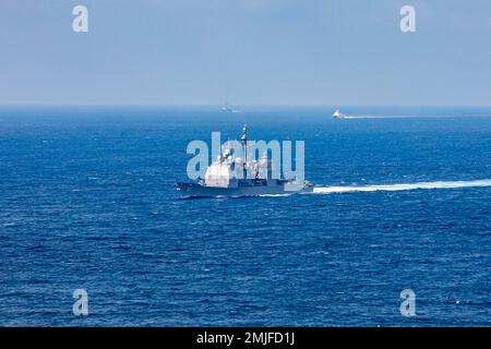 TAIWAN STRAIT (28 agosto 2022) l'incrociatore missilistico guidato di classe Ticonderoga USS Chancellorsville (CG 62) transita nello stretto di Taiwan durante un transito di routine vicino alle navi PLA(N). Chancellorsville è schierata in avanti nell'area delle operazioni della flotta degli Stati Uniti 7th a sostegno di un libero e aperto Indo-Pacific. Foto Stock