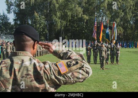 James R. Holmes III e laureati di classe 09-22 del 7th° Comand di addestramento dell'esercito (7ATC) corso di Leadership di base dell'Accademia non commissionata (NCOA) presentano le armi per il gioco dell'inno nazionale a Grafenwoehr, Germania, 30 agosto 2022. La missione NCOA 7ATC è formare e sviluppare futuri leader che siano adattabili, disciplinati e pronti a guidare efficacemente a livello di squadra e squadra. Foto Stock