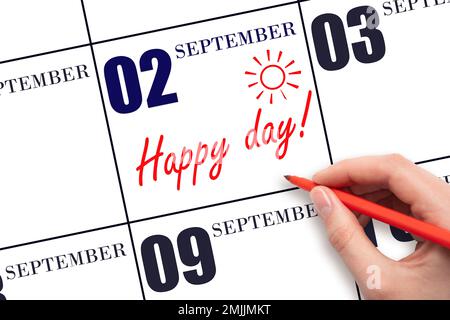 2nd° giorno di settembre. Scrivere a mano il testo HAPPY DAY e disegnare il sole sulla data di calendario 2 settembre. Salvare la data. Vacanza. Motivazione. Autom Foto Stock