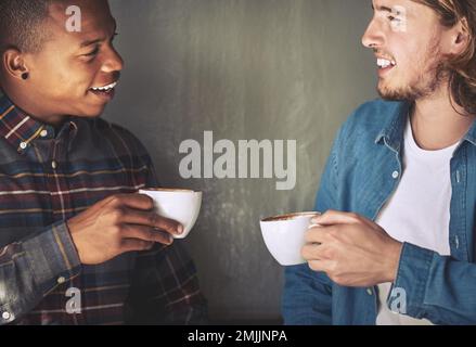 Buon caffè e buona conversazione. due amici che hanno un caffè insieme in una caffetteria. Foto Stock