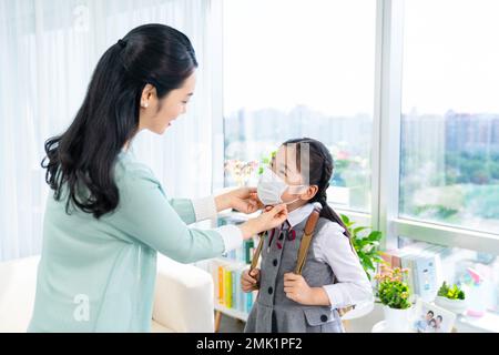 Da madre a figlia che indossa una maschera Foto Stock