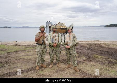 Da sinistra, Mate 3rd Class Ali Fayyad di Boatswain, Chief Warrant Officer Michael Fifer, E Engineman 1st Classe Jason Hook da Command Beachmaster Unit (BMU) 2, Expeditionary Strike Group (ESG) 2, United States Navy, posa per una fotografia dopo aver caricato i loro veicoli e le loro attrezzature a bordo di Landing Craft, Utility 1663 a Ilha do Governatador, Rio de Janeiro, 6 settembre 2022. La BMU-2 funge da controllore del traffico sulla spiaggia e fornisce squadre di Beach party della zona di atterraggio dell'imbarcazione a sostegno del movimento nave-terra per facilitare l'atterraggio del personale e delle attrezzature. Forniscono inoltre una capacità di recupero con Foto Stock