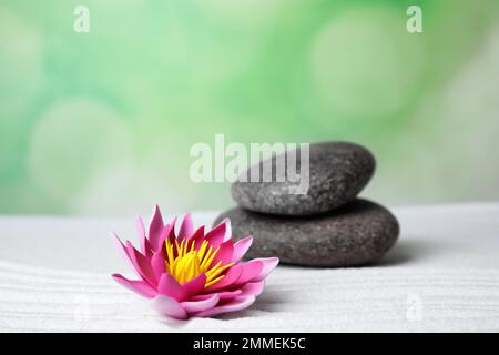 Giardino Zen. Bel fiore di loto e pietre su sabbia bianca Foto Stock