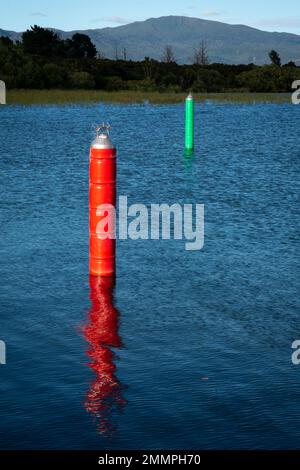 Indicatori di navigazione rossi e verdi su entrambi i lati del canale di navigazione che conduce a Motuoapu Marina, Lago Taupo, Isola del Nord, Nuova Zelanda Foto Stock