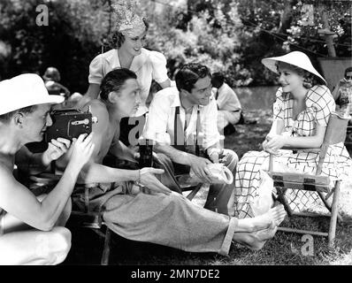 Il regista ELLIOTT NUGENT porta in scena filmati amatoriali privati dei membri del cast MISCHA AUER GRACE BRADLEY FRANCIS LEDERER e MADELEINE CARROLL sul set location candido durante le riprese di THE IT'S ALL YOURS 1937 il regista ELLIOTT NUGENT ingana il produttore Robert Kloch William Perlberg Columbia Pictures Foto Stock