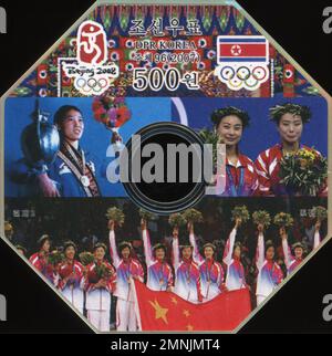 Francobollo ottagonale commemorativo della Corea del Nord per le Olimpiadi di Pechino 2008, con atleti, bandiera della RPDC e anelli olimpici. Foto Stock