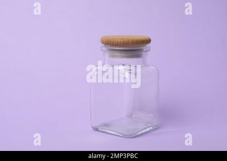 Vaso di vetro vuoto chiuso su sfondo lilla Foto Stock