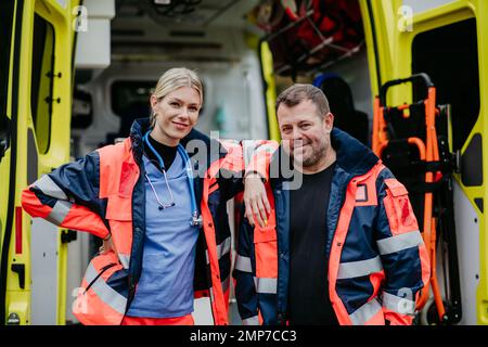 Ritratto dei soccorritori di fronte all'auto dell'ambulanza. Foto Stock