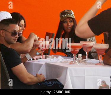 Michael 'The Situation' Sorrentino, Nicole 'Snooki' Polizzi e Jenni 'JWoww' Farley si siedono di fronte a enormi margaritas rosa mentre girano scene per la seconda stagione del famoso show di realtà MTV 'Jersey Shore'. Miami Beach, Florida. 04/06/10. Foto Stock