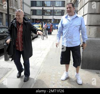 Il musicista scozzese Midge Ure si pone per la telecamera prima di dare al suo amico, radio host Dale Winton, un abbraccio dopo aver lasciato gli studi della BBC radio 1. Londra, Regno Unito. 07/08/10. Foto Stock