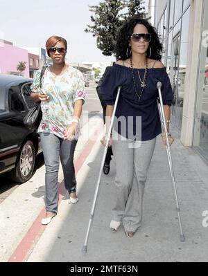La bellezza nata dalle Barbados, Rihanna, è stata avvistata passandole per i negozi, oggi, nonostante fosse su stampelle e indossasse una bretella sul piede. La cantante si è allietata con una terapia di vendita al dettaglio su Melrose Avenue e al Grove e ha trattato lei stessa e la sua amica con un gelato. Los Angeles, California 8/1/07. Tutti Foto Stock
