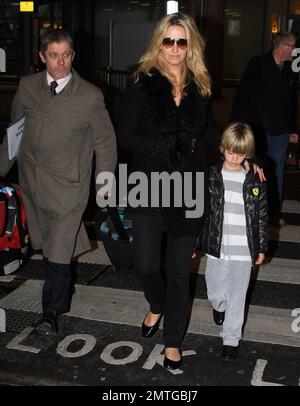 Rod Stewart, Penny Lancaster e i figli Aiden e Alistair arrivano all'aeroporto di Heathrow dopo un volo dagli Stati Uniti. La famiglia ha trascorso una lunga vacanza insieme a Miami e anche dopo un lungo volo con i bambini, Rod e Penny sembravano rinfrescati e rilassati mentre usciva dal terminal. Londra, Regno Unito. 12th gennaio 2012. Foto Stock