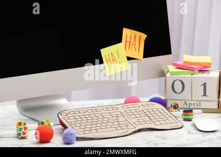 Computer con tastiera in cartone su tavolo in marmo bianco. Fool's Day di aprile Foto Stock