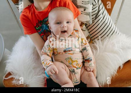 Ragazzo sdraiato in grembo Foto Stock