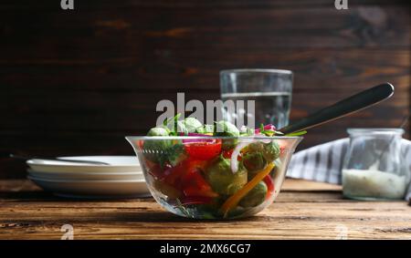 Gustosa insalata con germogli di Bruxelles servita su un tavolo di legno Foto Stock