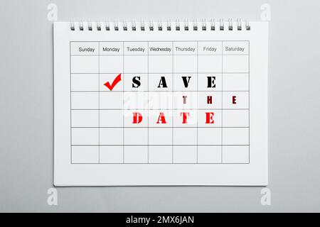 Calendario vuoto con frase CONSENTE DI SALVARE LA DATA su sfondo grigio chiaro, vista dall'alto Foto Stock