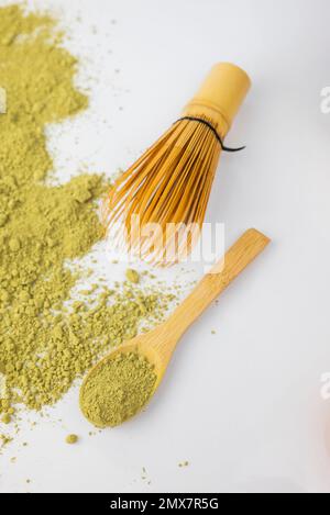 tè detox verde matcha con cucchiaio di legno secco e whisk di bambù Foto Stock