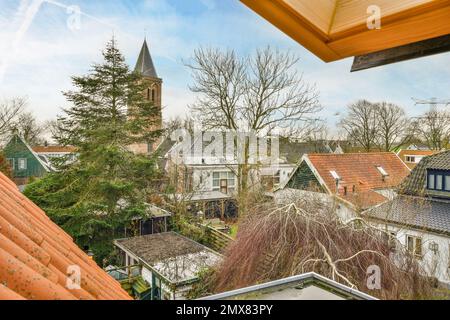 Vista dall'alto del villaggio suburbano con piccole case con tetti in tegole e cortili verdi Foto Stock