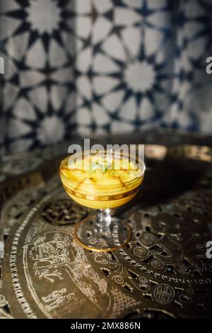 Sholeh Zard, un budino di riso allo zafferano persiano, dessert con crema di pistacchio e cannella Foto Stock