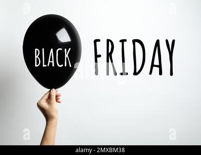 Concetto di Black Friday. Donna con palloncino su sfondo bianco, primo piano Foto Stock