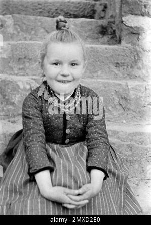 Porträt eines Mädchens in der Tracht des Schwalm-Eder-Kreises in Hessen, Germania, 1938. Ritratto di una ragazza che indossa il vestito tradizionale della regione di Schwalm-Eder in Assia, Germania, 1938. Foto Stock