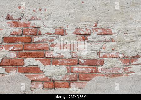 Vecchio muro di mattoni e sfondo a struttura in gesso rovinato Foto Stock