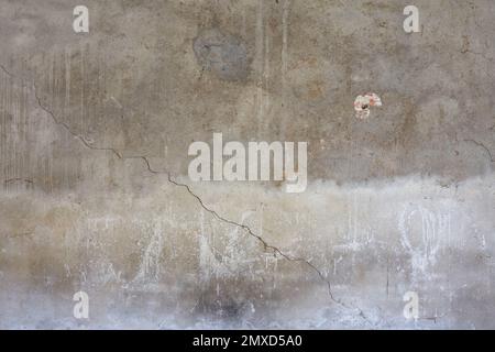 Parete grigia in cemento con crepe e macchie bianche sfondo texture Foto Stock