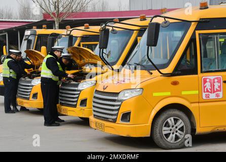 HANDAN, CINA - 3 FEBBRAIO 2023 - gli ufficiali di polizia effettuano controlli di sicurezza sugli autobus scolastici a Handan, provincia di Hebei, Cina settentrionale, 3 febbraio 2023. Foto Stock