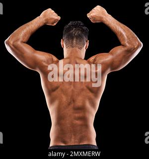 Ciò è che cosa chiamate gli obiettivi di idoneità. Ripresa posteriore di un giovane muscoloso che flette i muscoli su uno sfondo nero. Foto Stock