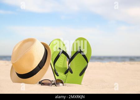 Diversi oggetti di stile spiaggia sulla sabbia vicino al mare Foto Stock