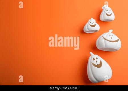 Portacandele a forma di zucca bianca e spazio per il testo su sfondo arancione, piatto. Decorazione di Halloween Foto Stock