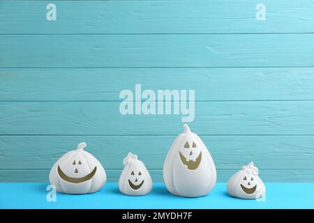 Portacandele a forma di zucca bianca su un tavolo azzurro. Decorazione di Halloween Foto Stock