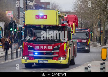 London Fire brigade Fire Engine con luci blu lampeggianti Camden High Street Foto Stock