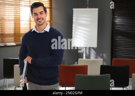 Giovane insegnante in attesa di studenti in classe Foto Stock