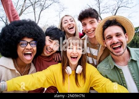 Gruppo multirazziale di amici felici che prendono un selfie in un parco urbano. Sorrisi e bei momenti. Foto Stock