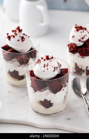 Trifle o parfait di velluto rosso con mousse di formaggio cremoso e panna montata, dessert in un'idea di vetro Foto Stock