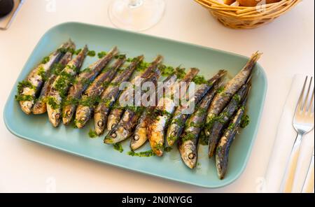 Sardine alla griglia con salsa di gremolata su piatto Foto Stock