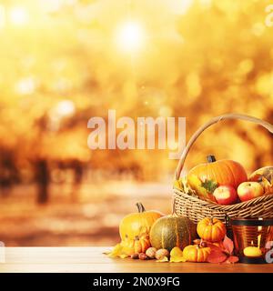 Buon giorno del Ringraziamento. Zucche fresche, ghiande, mele, noci e foglie cadute su un tavolo di legno all'aperto, spazio per il testo Foto Stock