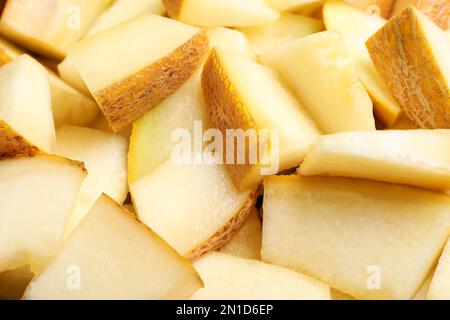 Pezzi di delizioso melone di miele come sfondo, primo piano Foto Stock