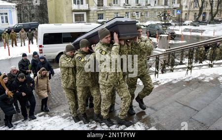 KIEV, UCRAINA - 06 FEBBRAIO 2023 - i partecipanti portano la bara durante la cerimonia funeraria per un ufficiale di intelligence delle forze speciali della Difesa Intelligence dell'Ucraina Eduard Shtraus, morto nella guerra contro la Russia, Kyiv, capitale dell'Ucraina. Foto Stock