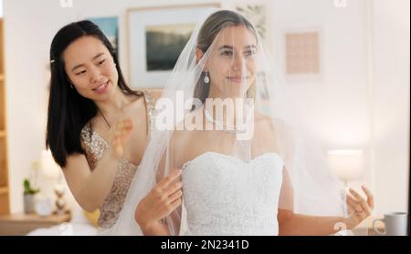 Sposa, matrimonio e donna che aiutano con il velo nel sorriso spogliatoio per un giorno speciale. Le donne felici amano e sostegno della bridesmaid o aiutare la sposa con Foto Stock