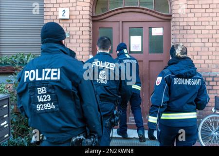 07 febbraio 2023, Brandeburgo, Cottbus: Le forze di emergenza dell'Ufficio dell'ordine pubblico della città di Cottbus e la polizia stanno suonando campane negli appartamenti. A partire da mezzogiorno di oggi, cercheranno di disinnescare una bomba aerea che è stata trovata durante i lavori di costruzione di giovedì. A tal fine è stata istituita una zona di esclusione di 1000 metri, in cui sono situate le case di circa 3800 persone, una scuola e un centro di cura, la stazione centrale di Cottbus e altre imprese commerciali. E 'dalle ore 8, evacuato. Il dispositivo esplosivo, che pesa circa 100 kg e comprende un tipo russo Foto Stock