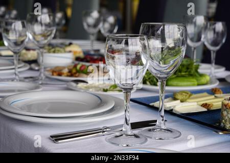 il tavolo è disposto per la celebrazione, ci sono bicchieri e insalata e snack, tonificante Foto Stock