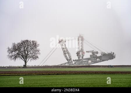 Escavatori della miniera di lignite di opencast Garzweiler II, nell'ex villaggio demolito di Lützerath, sulla strada di campagna L12, nella nebbia, NRW, Germania, Foto Stock