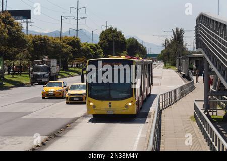 BOGOTA, COLOMBIA - Un autobus giallo Transmilenio con due taxi che transitano su 'autopista norte' o North Highway durante l'evento No car Day Foto Stock
